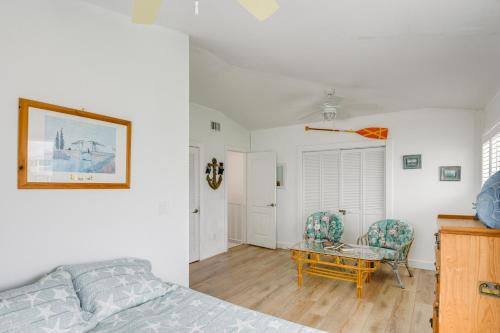 a bedroom with a bed and a table and chairs at Dock and Balcony Serene Big Coppitt Key Escape in Key West