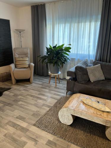 a living room with a couch and a table at Waldkristall in Überlingen