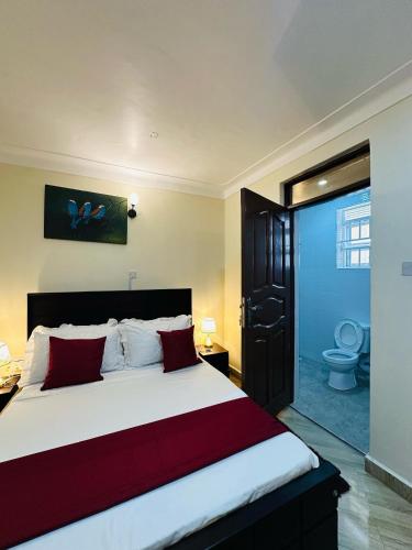 Postel nebo postele na pokoji v ubytování Coco Hotel Busia