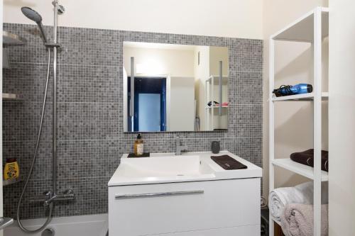 une salle de bain avec un lavabo blanc et une douche dans l'établissement Auguste Laurent - KP - Charming apartment with balcony 4 pers Paris 11, à Paris
