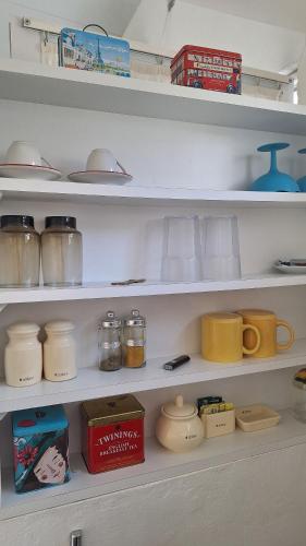 a white shelf with jars and other items on it at Apartamento 2 en el Centro de Chuy - Inmejorable Localización in Chuy