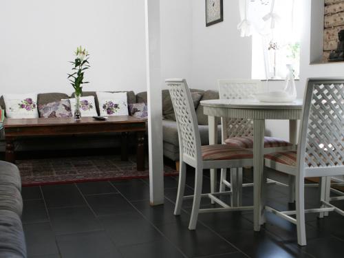 a living room with a table and chairs and a couch at Liverpoolsstugan in Motala