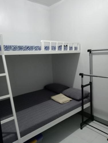 a room with two bunk beds and a ladder at Bahay Ko 2 transient home in Sariaya in Sariaya