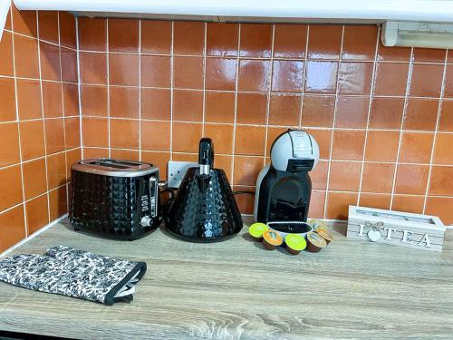 a counter top with a toaster and a coffee maker at Happy Sandy Feet in Youghal