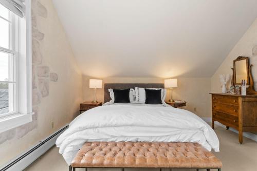 a bedroom with a large bed and a window at Red Clover Inn in Mendon