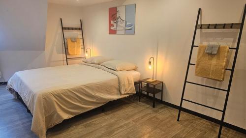 a bedroom with a bed and a ladder and a shelf at La tour des graffitis -T2-Wi-Fi in Sedan