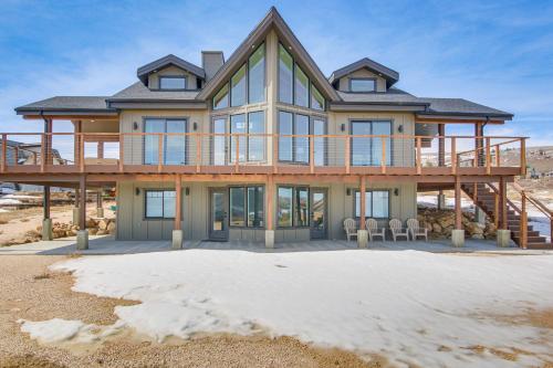 a large house with a deck on a beach at 5 Mi to Bear Lake State Park Home with Deck in Garden City