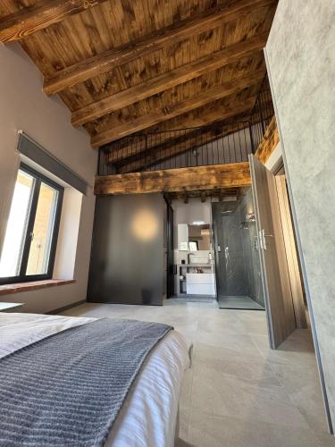 a bedroom with a bed and a wooden ceiling at Dimora Rosaspina in Adro