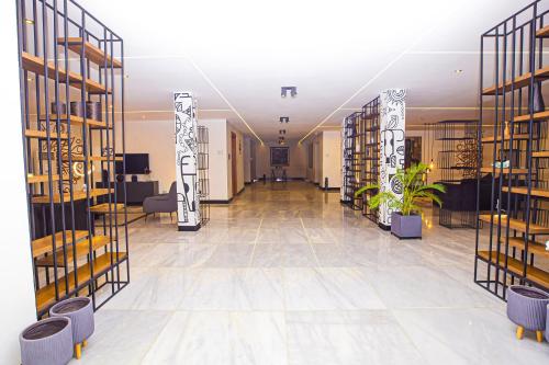 a large room with shelves with plants in it at Noble Nook Boutique Hotel Abuja in Abuja