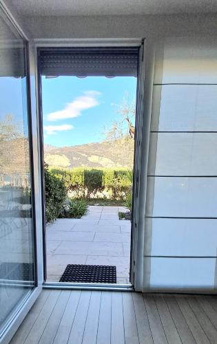 an open door to a porch with a view at Villa Treccani Apartments in Malcesine