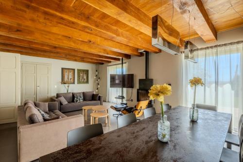 a living room with a table and a couch at Villa Aurora in Trecastelli
