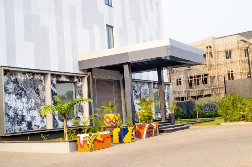 a building with a kiosk with plants in front of it at Noble Nook Boutique Hotel Abuja in Abuja