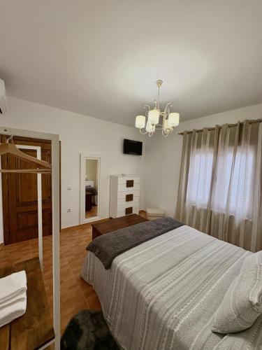 a bedroom with a bed and a chandelier at Alojamiento rural La Dama del Quijote 2 in El Toboso