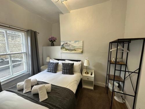 a bedroom with a white bed and a window at City Guesthouse in Oxford