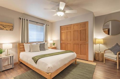 a bedroom with a large bed with a ceiling fan at 4 Beds! Walk to Town! Grnd Floor Condo, Modern, Summer AC in Leavenworth