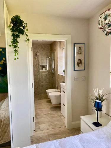 a bathroom with a tub and a toilet and a sink at Deerpark Stables in Highstreet