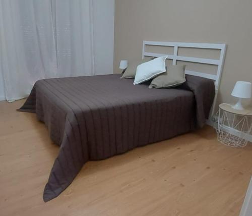 a bedroom with a large bed with pillows on it at La casa de San Miguel in Villalpando