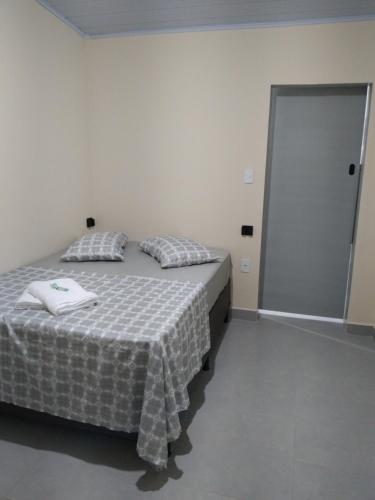 a bedroom with a bed and a sliding door at Pousada Santa Rita in Roseira