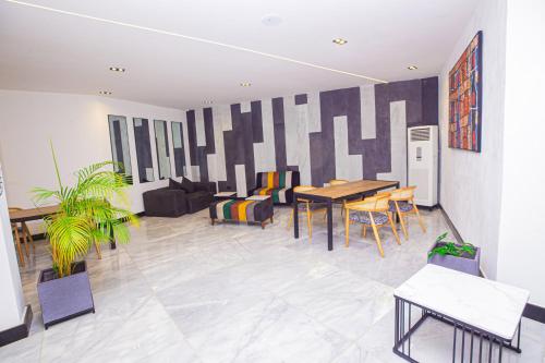 a living room with a table and chairs at Noble Nook Boutique Hotel Abuja in Abuja