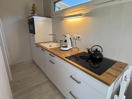a kitchen with a counter with a tea kettle on it at Tiny Tännle in Rust