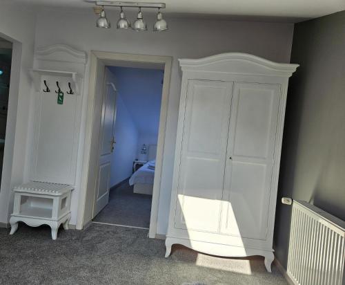a room with a white cabinet and a bedroom at Meteor Central in Cluj-Napoca