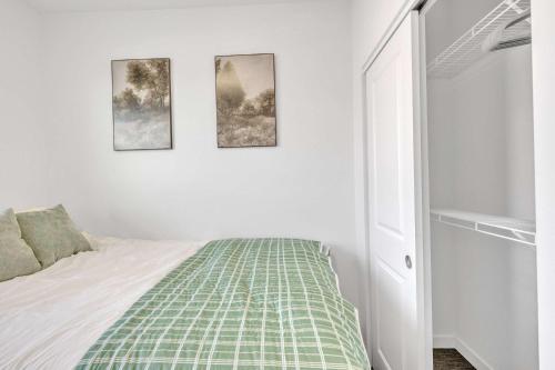 a bedroom with a bed and three pictures on the wall at Cozy Stay by Clark Fork River and near DT in Missoula