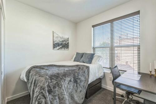 a bedroom with a bed and a desk and a window at Cozy Stay by Clark Fork River and near DT in Missoula