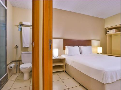 a hotel room with a bed and a toilet at Thermas de Olimpia Resort in Olímpia
