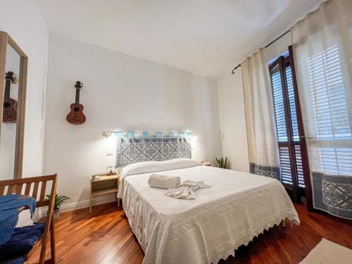 a bedroom with a bed with a white bedspread at B&B Il Mare di Terrasini in Terrasini