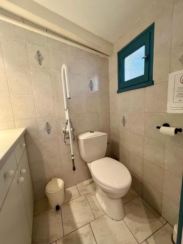 a bathroom with a toilet and a phone on the wall at Hotel Le Ponteil in Antibes