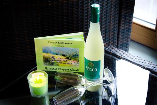 a bottle of wine and a candle on a table at Reiterhof Berggut Gaicht in Nesselwängle