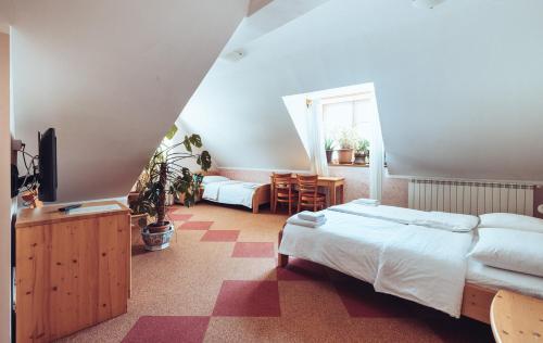 a bedroom with two beds and a couch and a table at Martinov Hram in Bovec