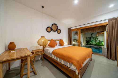 a bedroom with a bed and a desk and a window at A9 - Exclusive 3-Bedroom Villa in Seminyak with a Rooftop Paradise in Kerobokan