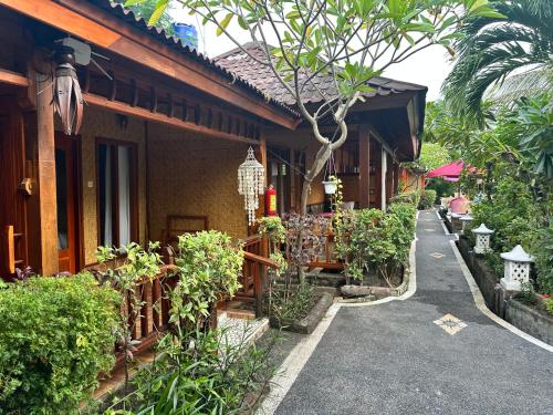 a house with a walkway next to a building at Sunny Rose Bungalows Gili Air - Adults only in Gili Air