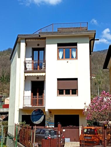 a white house with a fence in front of it at I Mosaici Guesthouse Luxury Apartment in Ronco Scrivia