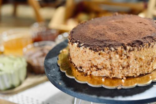 a chocolate cake on a plate on a table at Palermo Inn Boutique Hotel in Palermo