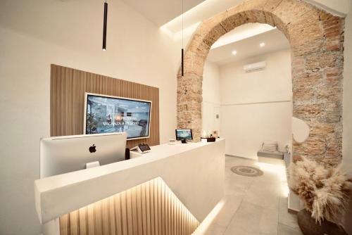 an archway in a room with a reception counter at Palermo Inn Boutique Hotel in Palermo