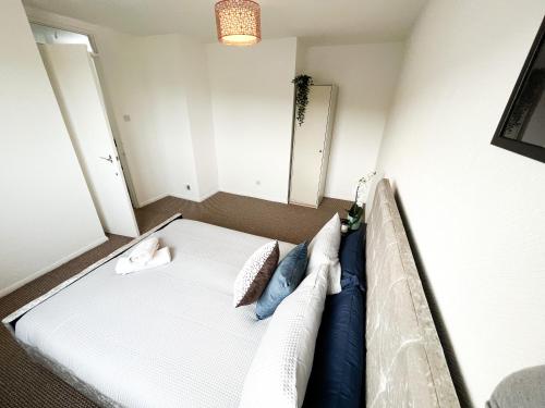 a small bedroom with a bed with blue pillows at 3 Bedroom House, WiFi & Free Parking in Chatham