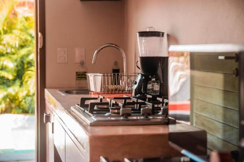 a kitchen counter with a coffee pot on a stove at Shankara Holbox in Holbox Island