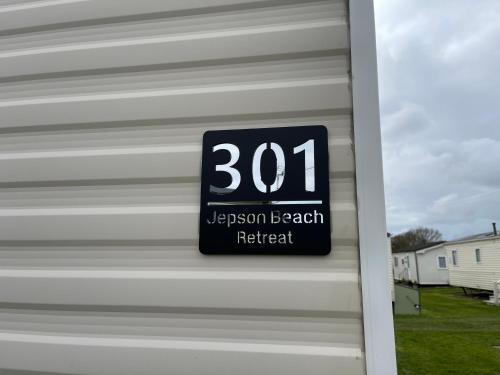 a clock on the side of a garage at Mablethorpe Seaside - Jepson Beach Retreat in Mablethorpe