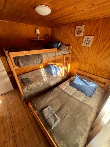 an overhead view of two bunk beds in a cabin at Cabañas Campestres Inés in Chillán