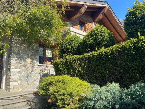 a house with a bunch of bushes in front of it at Casa degli iris in Quart