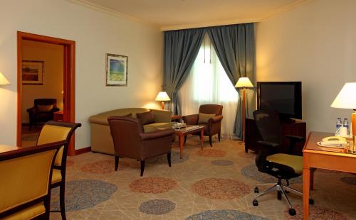 a hotel room with a living area and a living room at Holiday Inn Al Khobar by IHG in Al Khobar