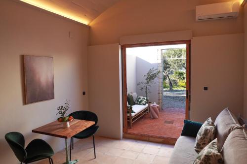 a living room with a couch and a table at Hotel Finca Olivar in Benissa