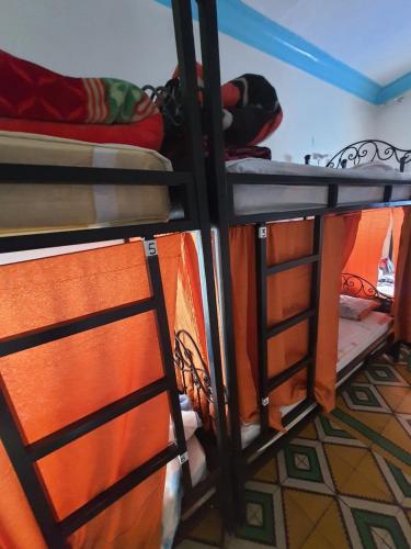 a group of bunk beds in a room at Hostel ALINE in Chefchaouene