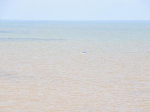 a small boat in the middle of the water at 98 Waterside Park in Lowestoft
