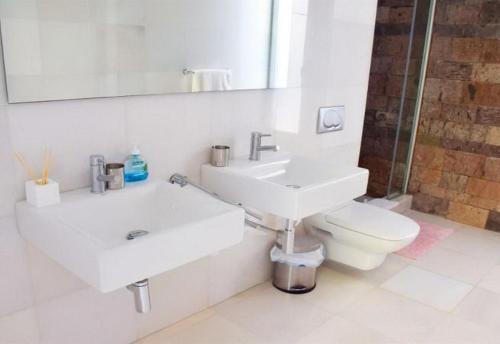 a white bathroom with a sink and a toilet at 5-bedroom Villa in Playa del Duque in Adeje
