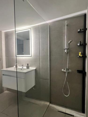 a bathroom with a shower and a sink at Rio luxury apts in Strovolos