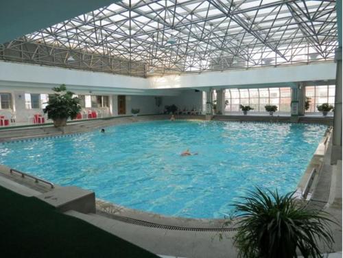 a large pool of water with a person in it at Kunming Golden Spring Hotel in Kunming