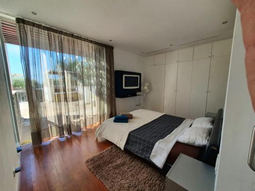 a bedroom with a bed and a large window at 5-bedroom Villa in Playa del Duque in Adeje
